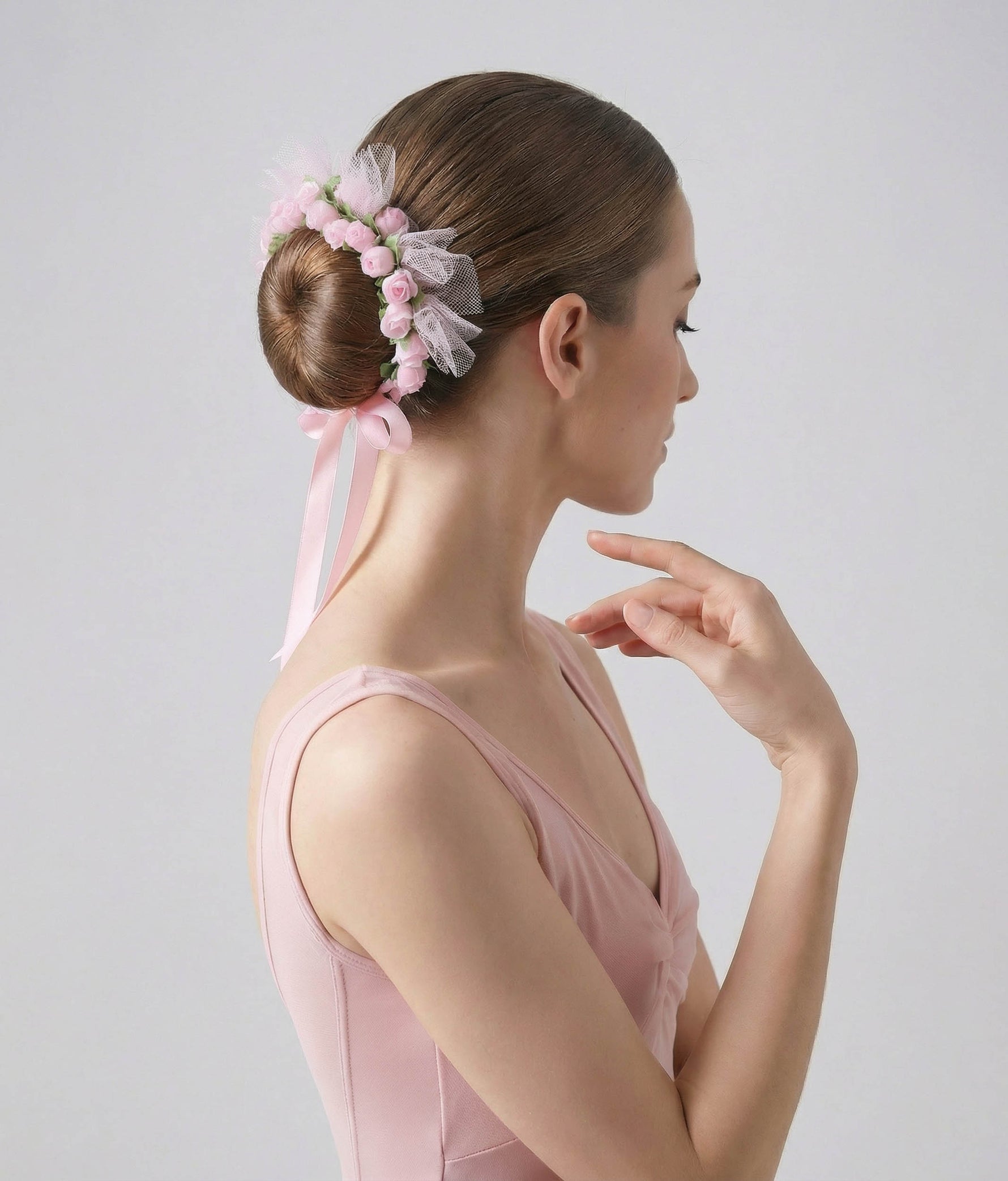 Ballerina with a floral hair accessory and pink dress on a plain background #rose_one