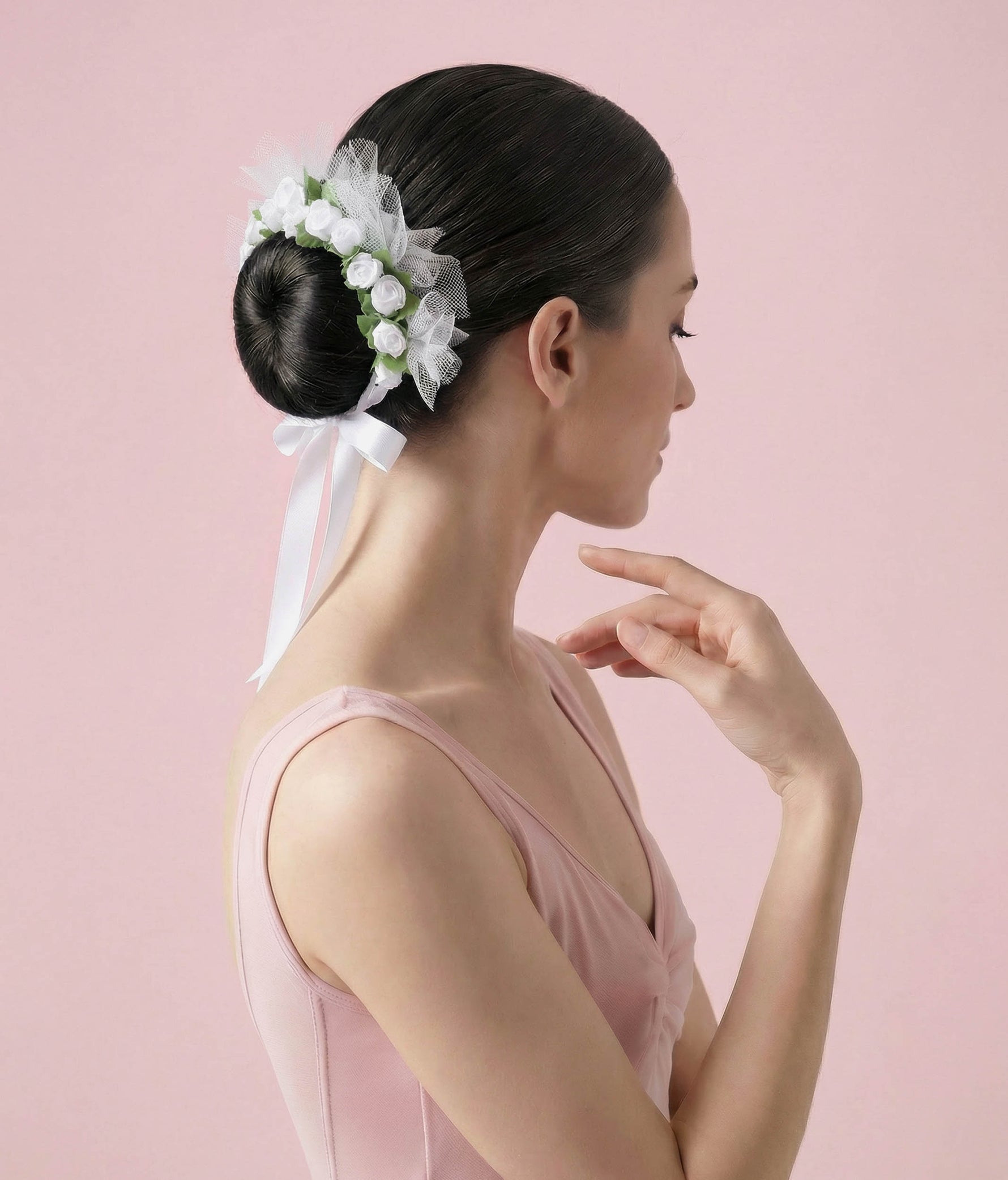 Ballerina with a floral hair accessory and pink dress on a plain background 