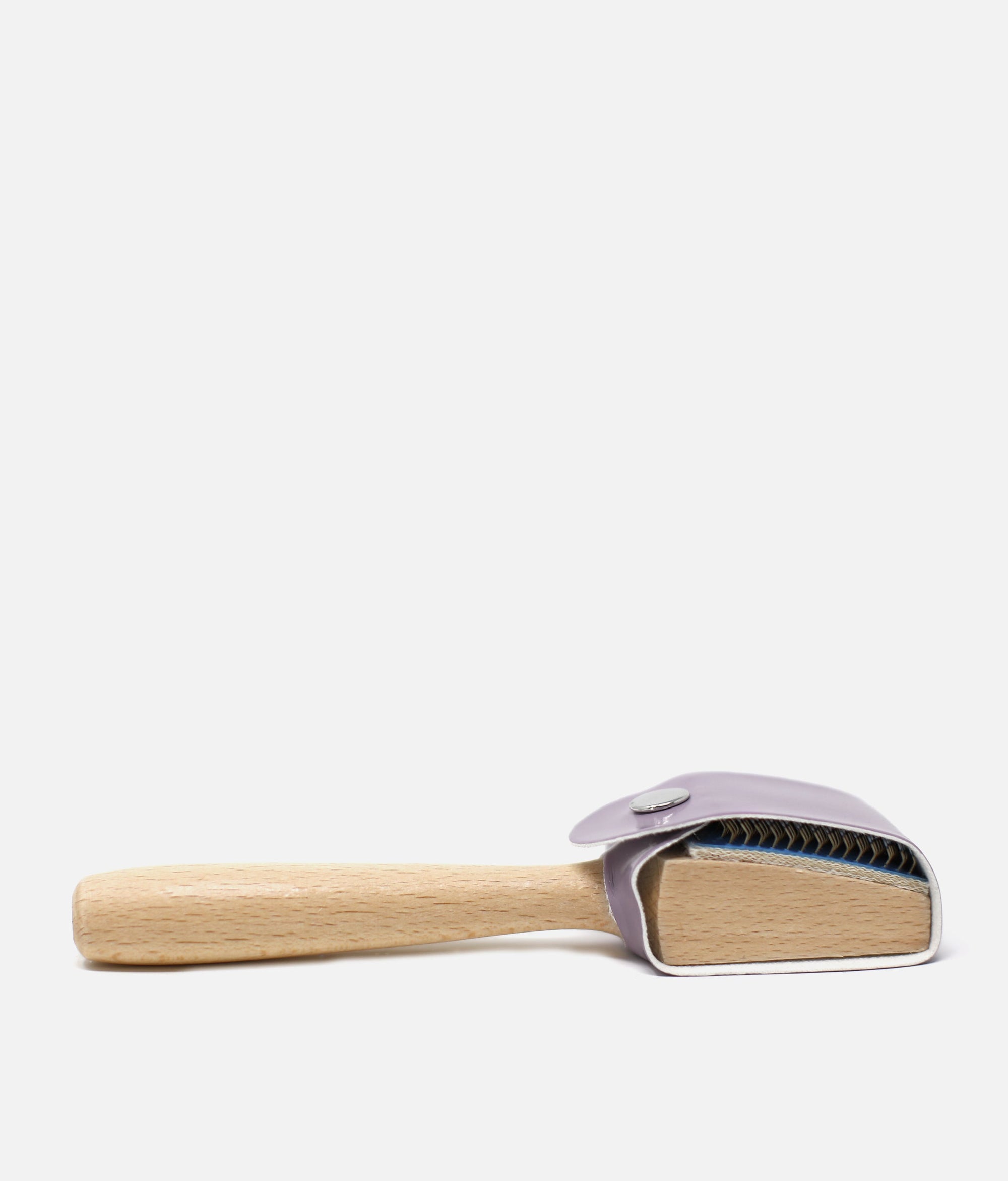 Pet grooming brush with wooden handle and purple head on a white   background  #light-grey_one